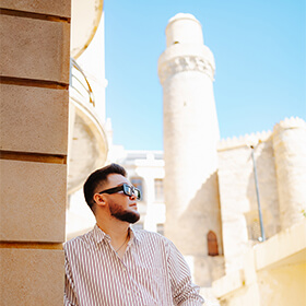Portrait of a visitor beside the Maiden Tower during a photography walking tour in Baku Old Town.